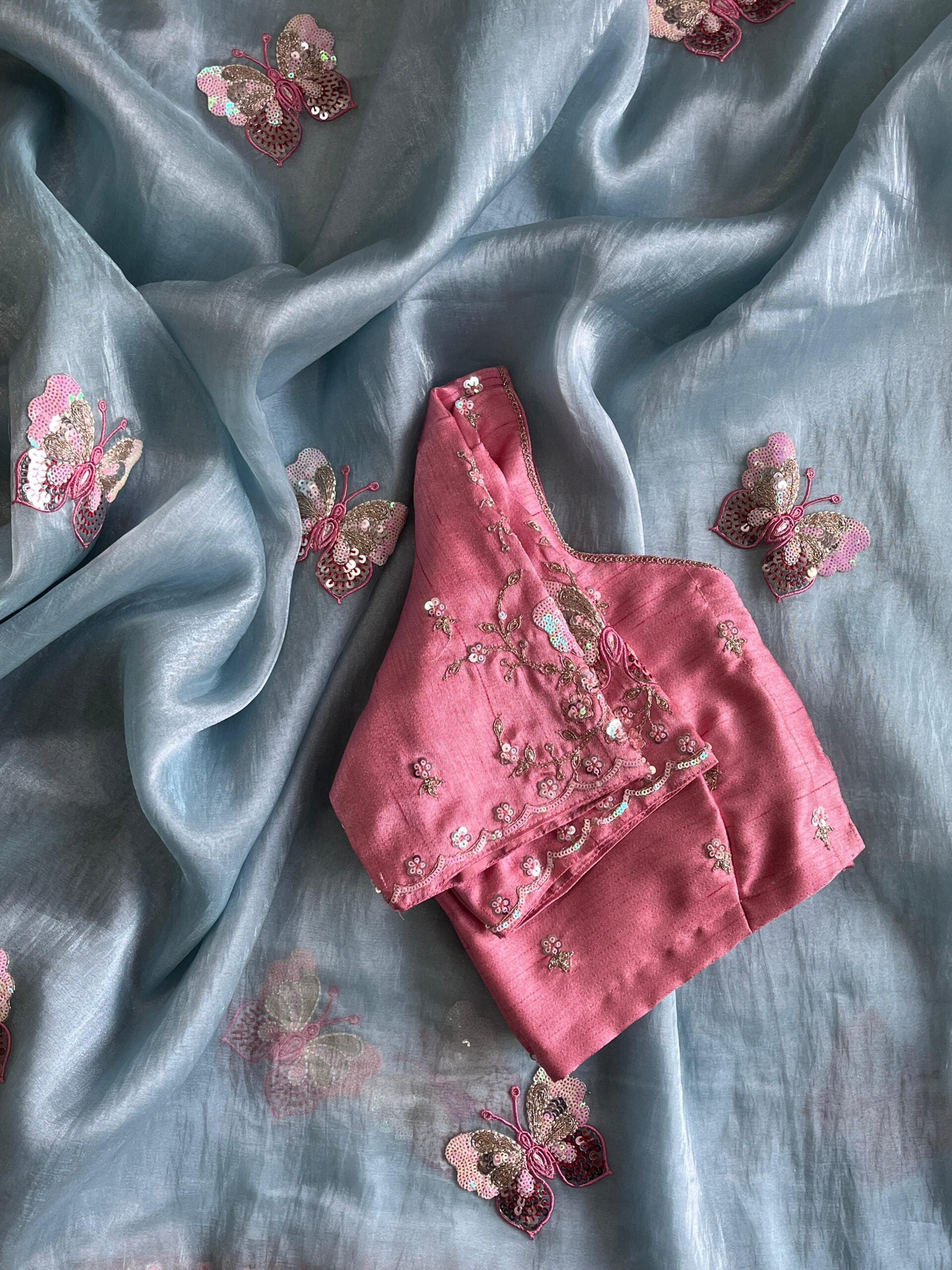 Premium Organza saree with elegant butterflies coding work on all over the sareeScalloped Coding work on either sideContrast piping attached on sareeDesigner Butterfly Tassels as shown Teamed with Designer Stitched blouseFree Size Blouse