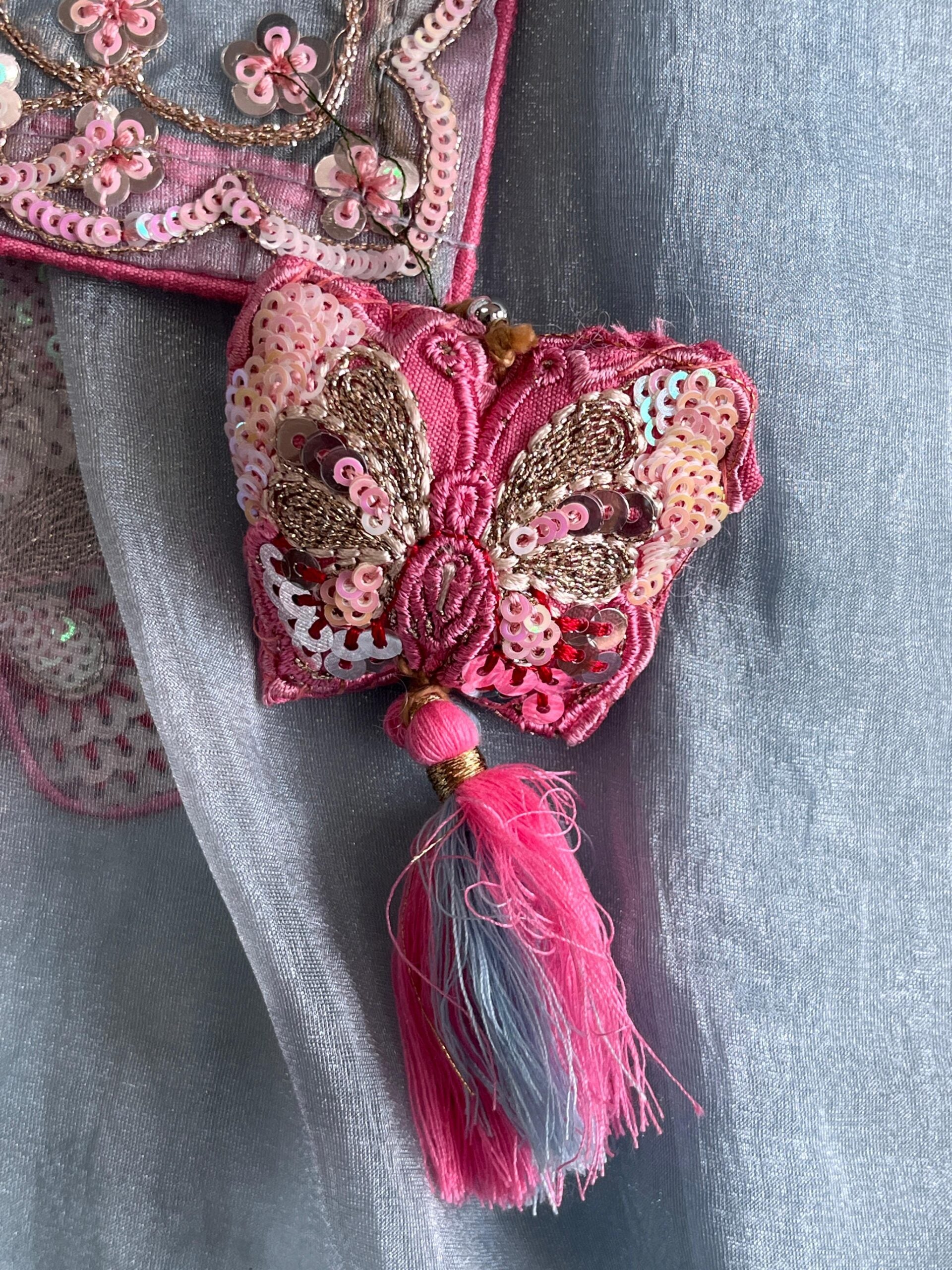 Premium Organza saree with elegant butterflies coding work on all over the sareeScalloped Coding work on either sideContrast piping attached on sareeDesigner Butterfly Tassels as shown Teamed with Designer Stitched blouseFree Size Blouse