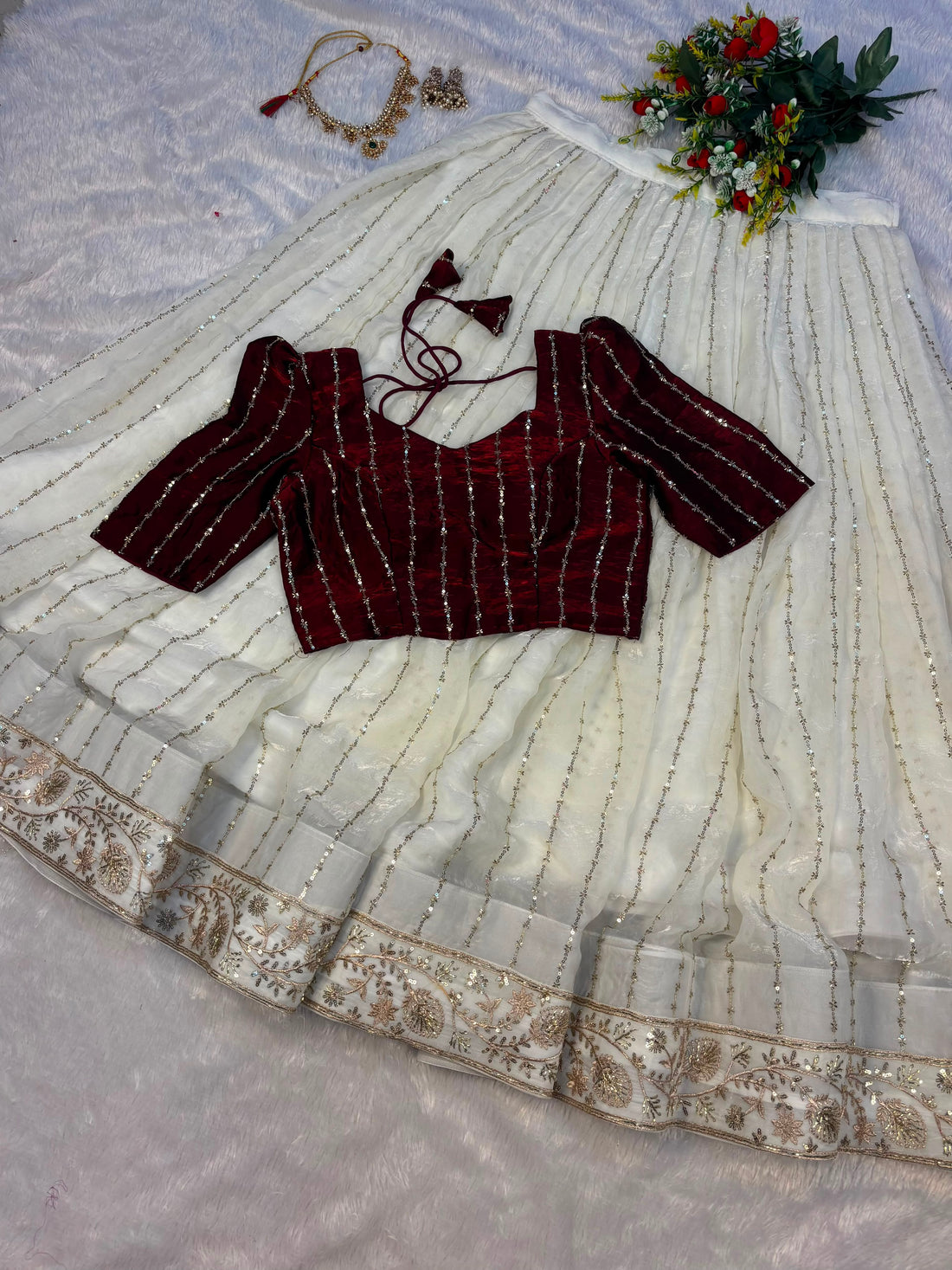 Premium Crop top adorned with intricate bead work with Fully flared premium shining net skirt embellished with all-over sequins work