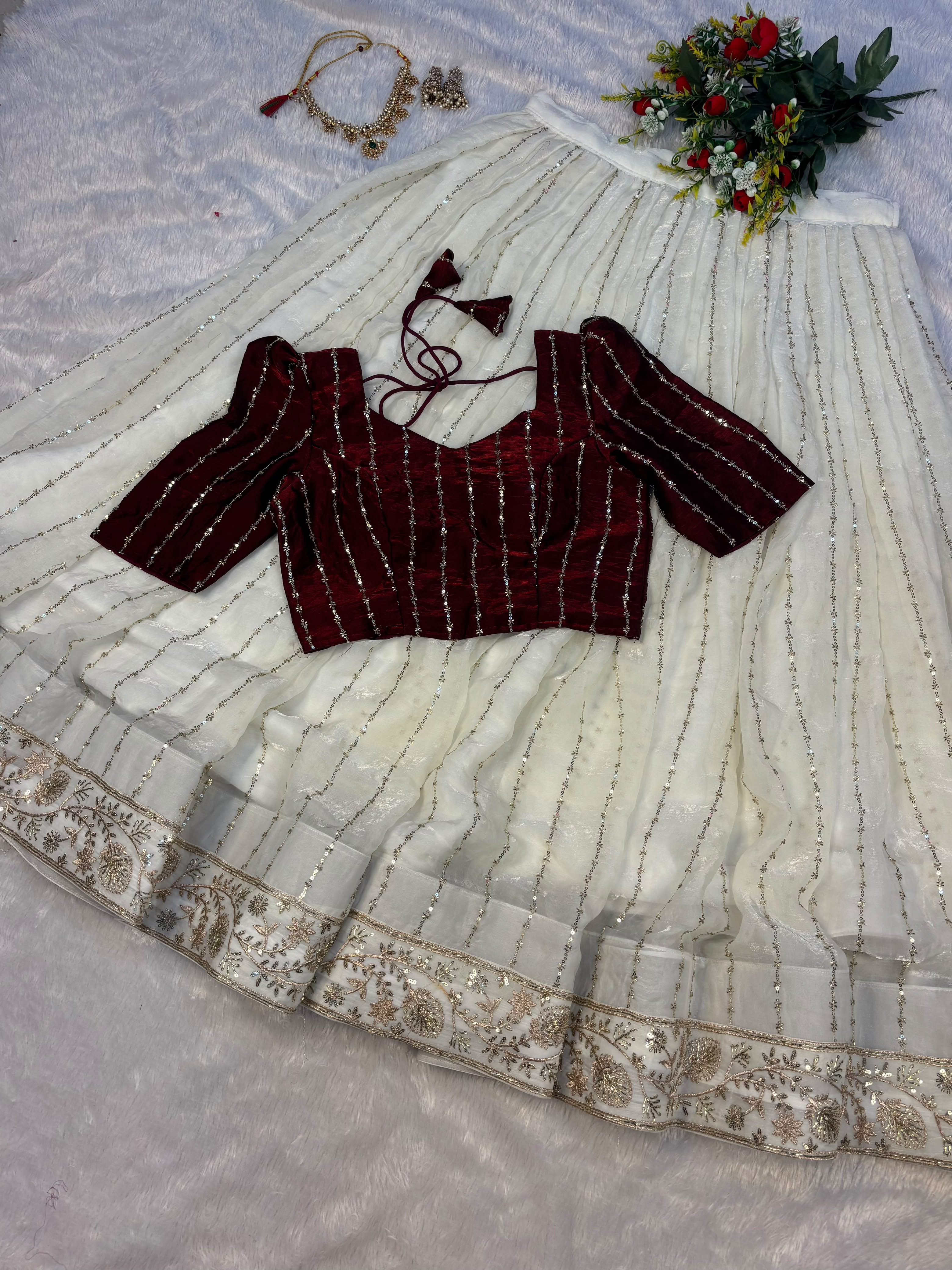 Premium Crop top adorned with intricate bead work with Fully flared premium shining net skirt embellished with all-over sequins work